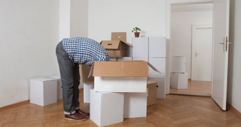 Organiser son déménagement personne penchée la tête dans des cartons de déménagement